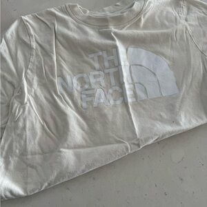 Used women’s north face t short cream and white size large 
Used once